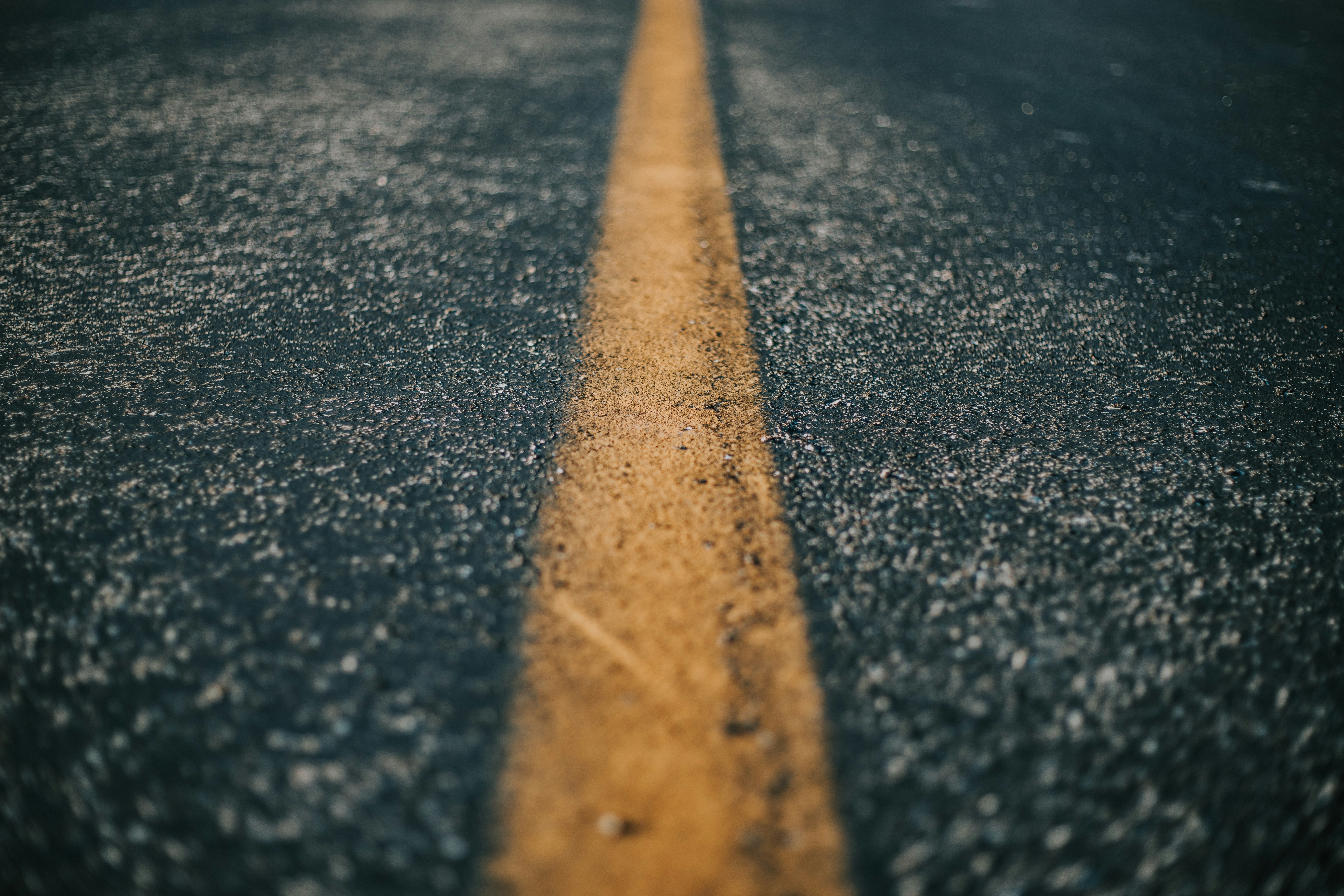 shallow focus of gray asphalt road